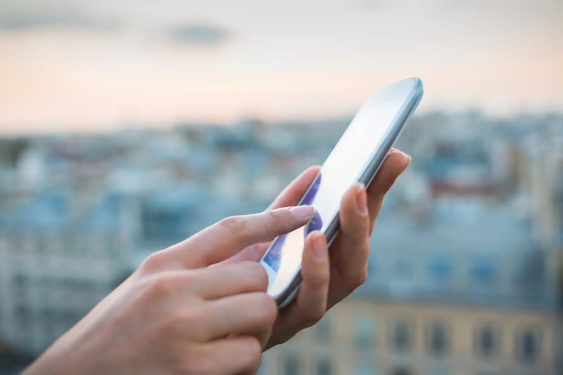 tesa woman using smartphone with city background