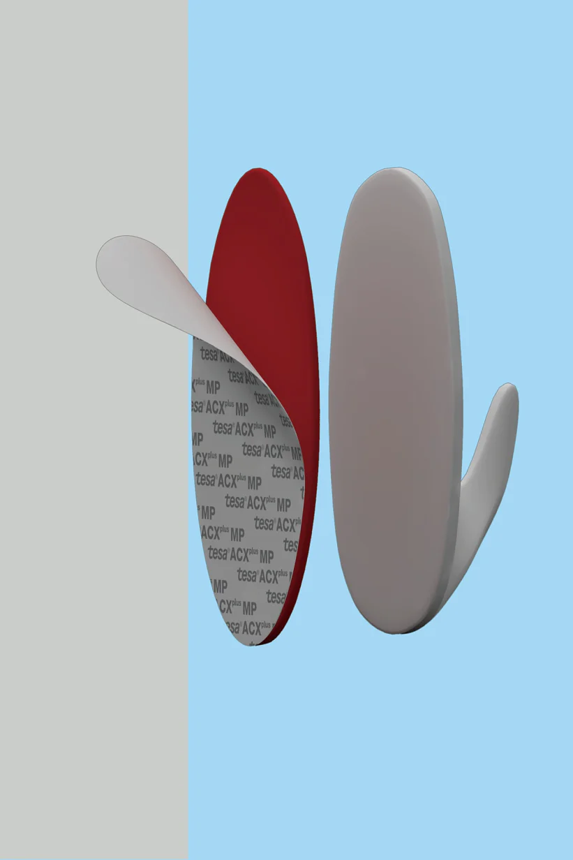 Two adhesive wall hooks are shown in profile against a divided background of light gray and blue. One hook is white with a visible sticky tesa tape surface, while the other is mounted, featuring a red tesa tape backing. (This text has been generated by AI)