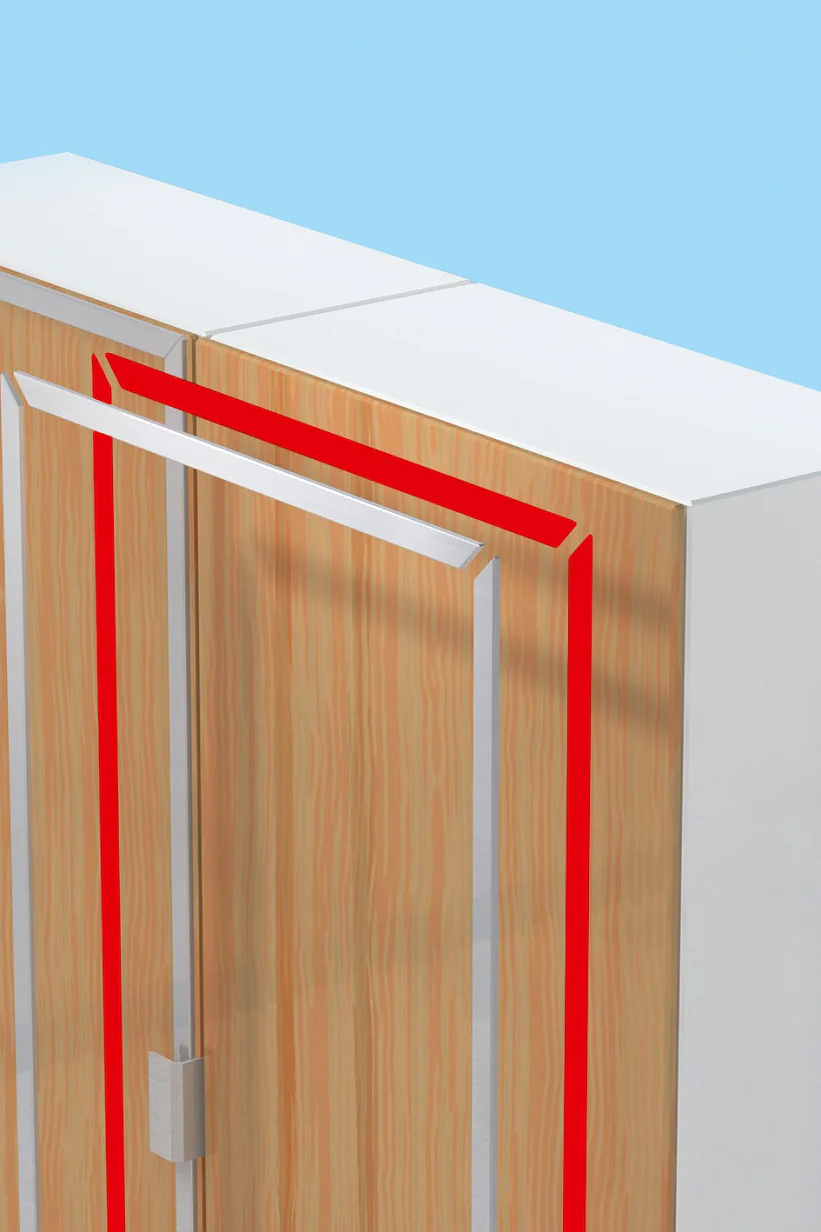 A close-up view of a partially open wooden cabinet against a light blue background. The cabinet doors have a white exterior with a wood-grain finish inside, and are outlined with a red strip of tesa tape. (This text has been generated by AI)