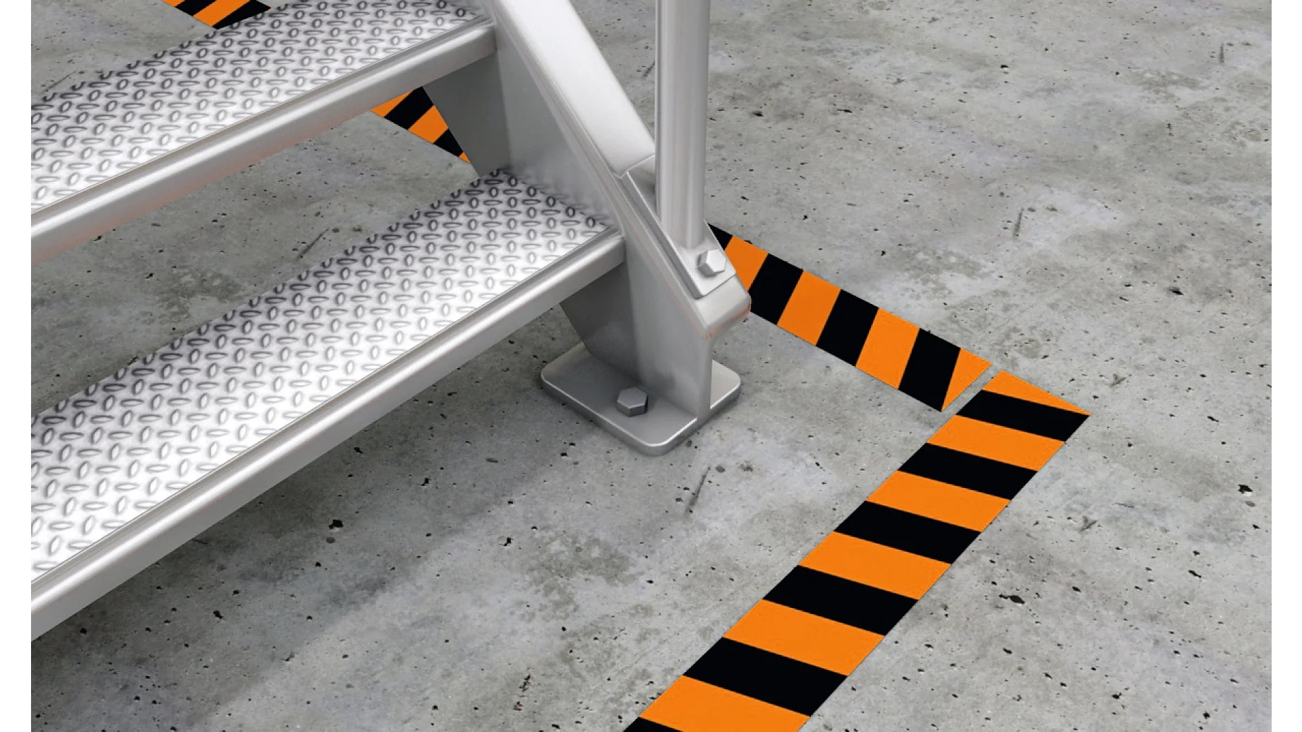 Metal steps are shown on a concrete surface marked by diagonal orange and black caution stripes, indicating a designated safety area. The step surface has a textured metal pattern for grip. (This text has been generated by AI)