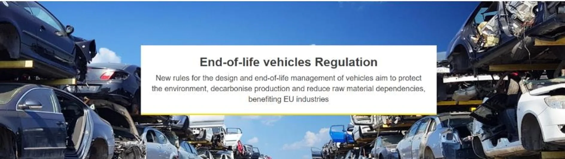 Stacks of scrapped vehicles are piled on either side of a road, visible under a clear blue sky. A central banner reads: End-of-life vehicles Regulation, with additional text about new environmental rules. The banners and signs are secured using tesa tape to ensure they remain prominently displayed despite the wind and weather conditions. (This text has been generated by AI)