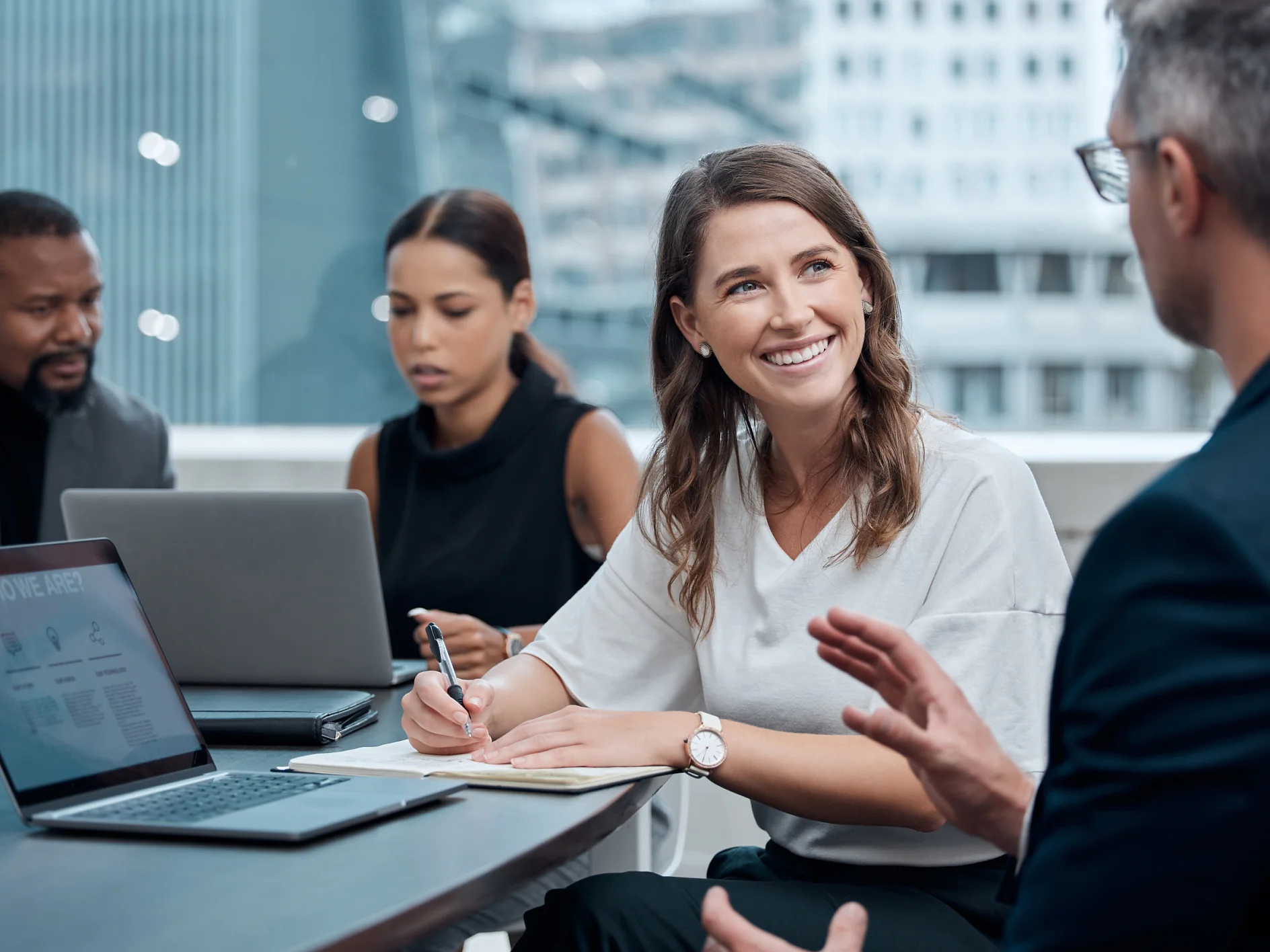 Diversity, professional woman and meeting in office for collaboration, teamwork and brainstorming with laptop. Technology, business people and group in corporate workplace for strategy and research.